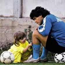 Diego Maradona's daughter picks a flower for her father, which he proudly wears during training 1989